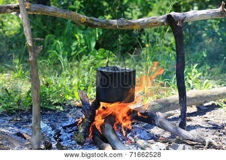 Smoked tourist kettle on camp fire 