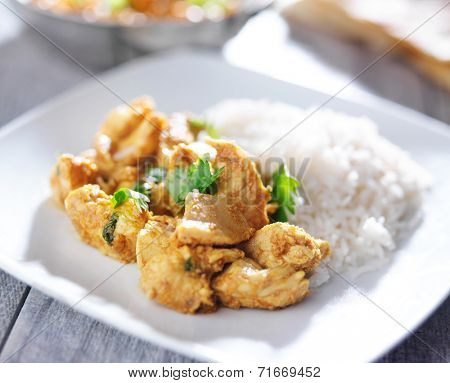plate of indian butter chicken curry with basmati rice