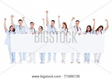 Group Of Healthcare Personnel Holding A Banner
