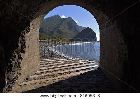 View Of Beach Through Tunnel