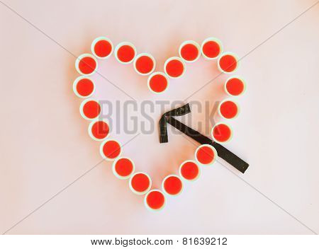 A Heart Of Glasses Hit By An Arrow Of Chocolate
