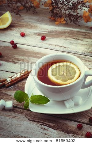 A cup of tea with lemon,cinnamon and mint leaf