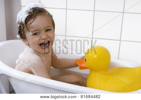 Cute Toddler Playing In A Bathtub
