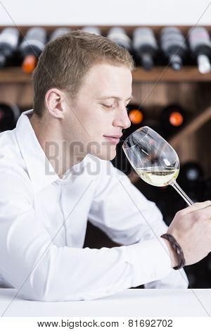 Man Smelling A White Wineglass