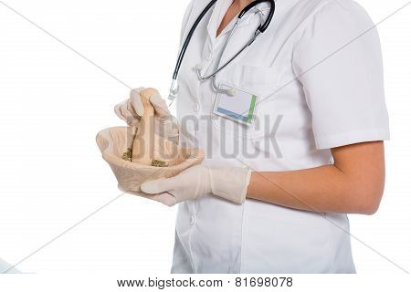 Woman doctor using a mortar and pestle, herbal medicine