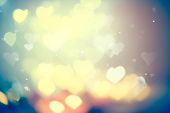 Holiday abstract glowing blurred background, bokeh. Defocused blinking heart shaped lights, vintage 