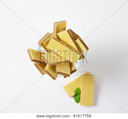 chocolate wafers in glass rummer on white background