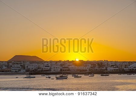 Sunset In The Harbor  With Sailing Boats