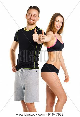 Athletic Man And Woman After Fitness Exercise With Thumbs Up On The White