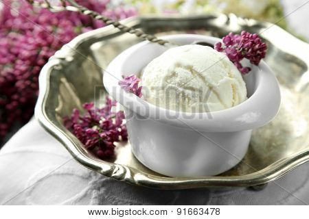 Beautiful composition with tasty ice cream and lilac flowers