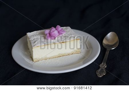 Slice Of Cheesecake On A Dark Surface