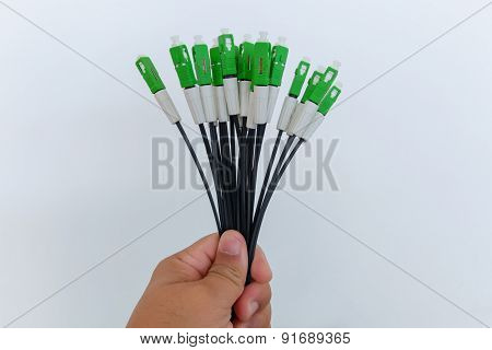 A group head connector fiber optic green color in hand on white background.Fiber Optics connectors.