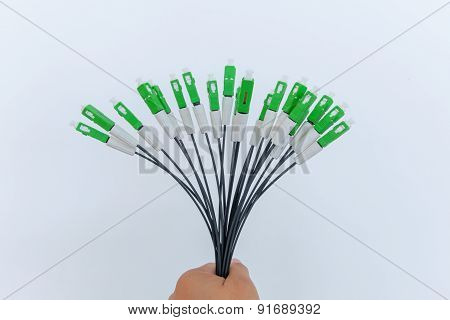 A group head connector fiber optic green color in hand on white background.Fiber Optics connectors.