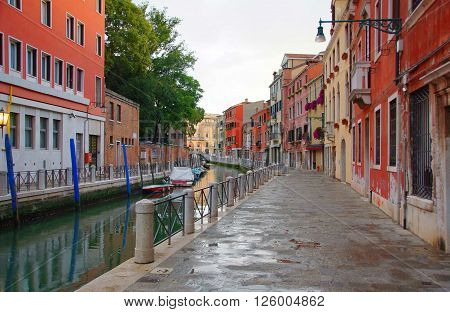 Morning rain in Venice. Gloomy morning. Canal and boats