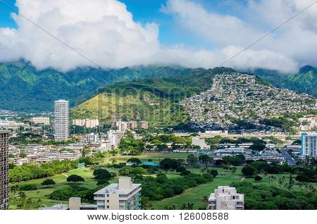 Waikiki, Honolulu, Hawaii, USA - Dec 15, 2015: Morning view of the Palolo region that backs against the distant hills. The cloud patterns were dramatic. Image taken on the 30th floor of the Hyatt Regency Hotel.