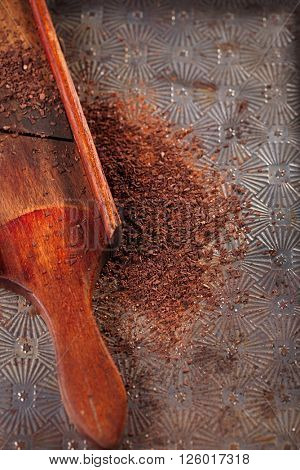 grated 100% dark chocolate flakes on vintage  wooden grate,   shallow DOF