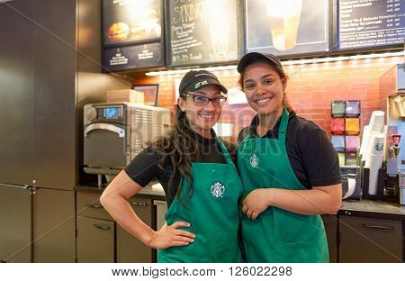 NEW YORK - CIRCA MARCH 2016: workers at Starbucks Cafe. Starbucks Corporation is an American global coffee company and coffeehouse chain based in Seattle, Washington
