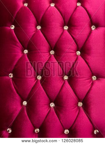 Red upholstery velveteen decorated with crystals as texture and pattern