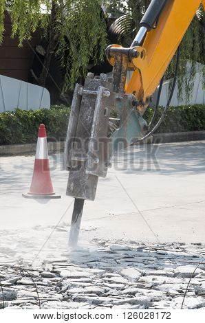 Excavator Breaking And Drilling The Concrete Road For Repairing