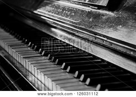 Old rusty piano keyboard, selective focus, black and white