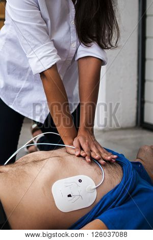 a rescuer assisting an unconscious man with cardiac resuscitation