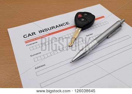 motor insurance with car key and pen
