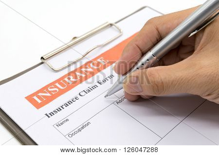 Man hand holding a pen Car insurance form document