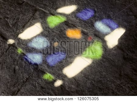 reflection of colorful antique window at the old cobble stone