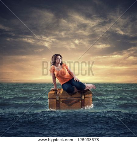 Teenager sitting on a treasure trove in the ocean
