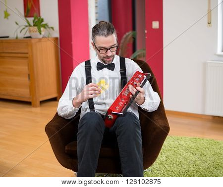 Man In White With Old Cassette Tape Deck In His Living Room