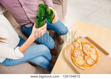 Top View Photo Of Man And Woman Clinking With Bottles Of Beer
