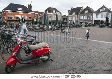 harderwijk, netherlands, 1 april 2016: people enjoy nice spring day on the market of dutch town harderwijk while children run around