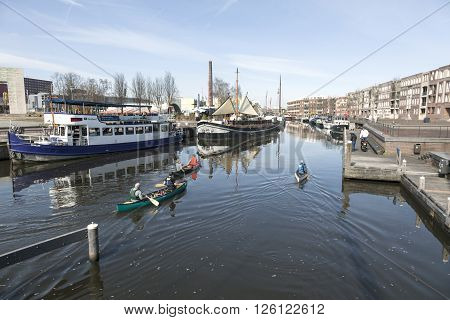 amersfoort, netherlands, 1 april 2016: people in canoes on river Eem in centre of old dutch city Amersfoort on nice spring day
