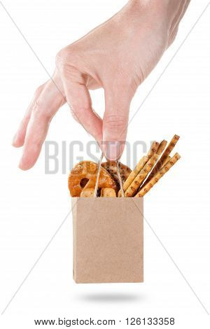 Snack bag hold in hand isolated on white. Delivery and sale of food. Cookie bread and cracker in supermarket package ready for logo design presentation.