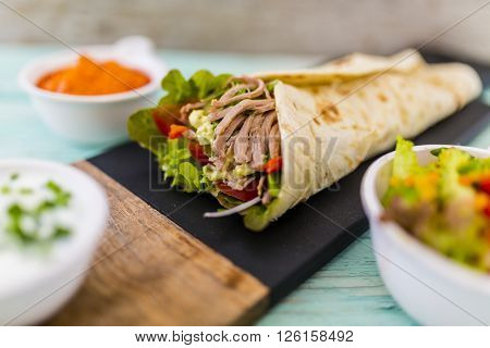 Tortilla with pulled pork, fresh vegetables
