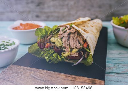 Tortilla with pulled pork, fresh vegetables
