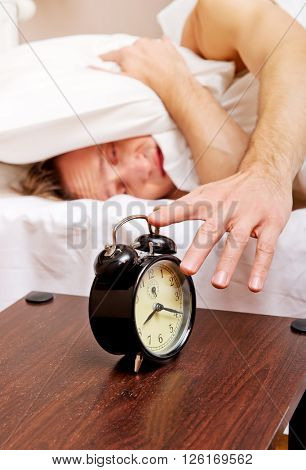 Man trying to sleep, when alarm clock ringing