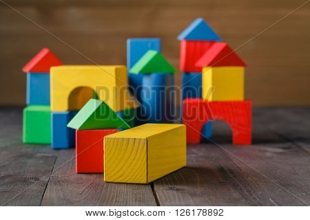 building from wooden colourful childrens blocks on table