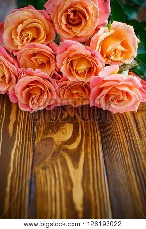 bouquet of pink roses on a wooden table
