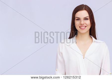 Portrait of happy business woman on grey background