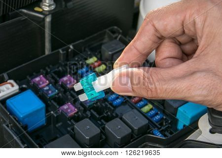 Auto mechanic checking a car fuse, mechanic, auto, fuse, closeup,