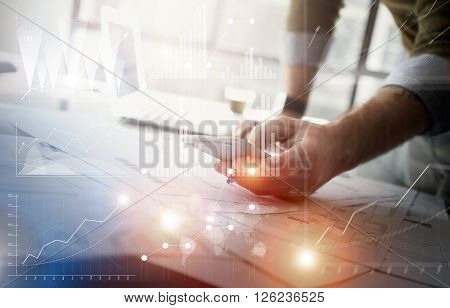 Business concept picture.Finance manager working new startup project modern office.Touching contemporary smartphone. Worldwide connection technology, stock exchanges graphics interface.