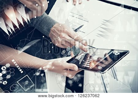 Photo female hands holding modern tablet and man touching screen.Businessmans crew working new investment project  office.Using electronic devices.Graphics icons, stock exchanges interface.