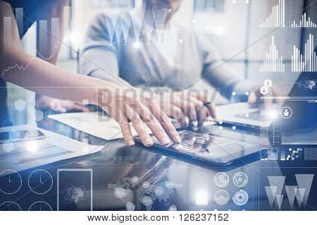 Closeup photo female hands touching screen modern tablet. Bankers team working new investment project in office.Using electronic devices. Graphics icons, stock exchanges interface.