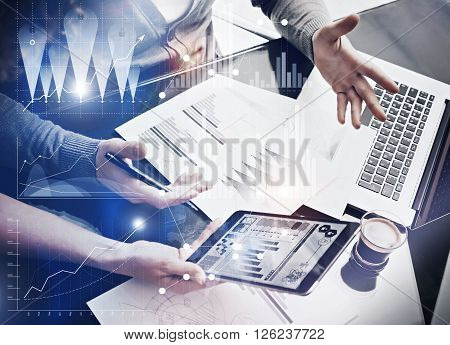 Photo business team brainstorming.Finance department managers working new global project in office.Using electronic devices.Graphics icons, worldwide stock exchanges interface on the screen.