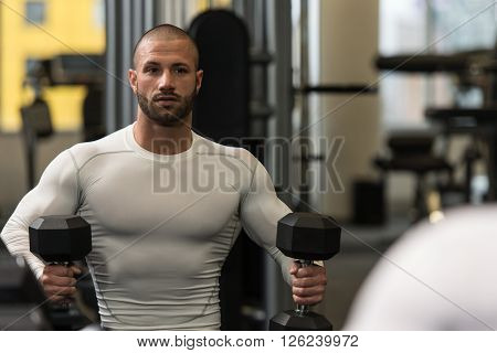 Young Male Bodybuilder Resting Between Workouts In Gym