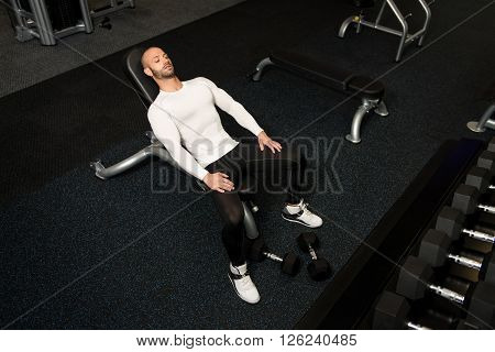 Young Male Bodybuilder Resting Between Workouts In Gym
