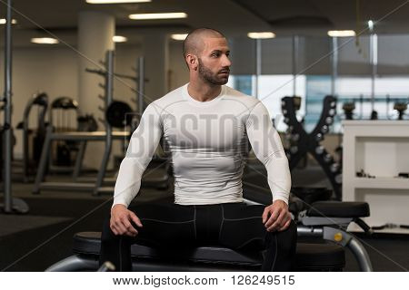 Young Man Resting In Healthy Club After Exercising