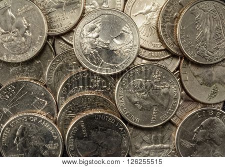 United States Coins quarters in a pile poverty riches savings thrift old and new state coins George Washington