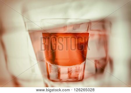 Abstract first person perspective of being drunk and reaching for another glass of alcohol. Blurred vision, concept background.
